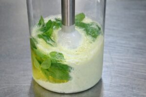 Maionese al basilico in preparazione con frullatore a immersione, emulsione vegetale senza uova